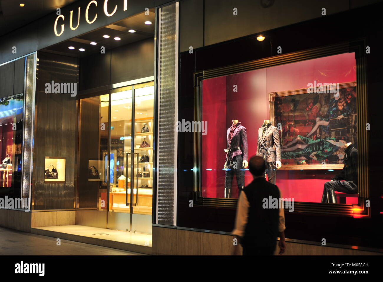 Window shopping customer enjoys Gucci clothing Stock Photo