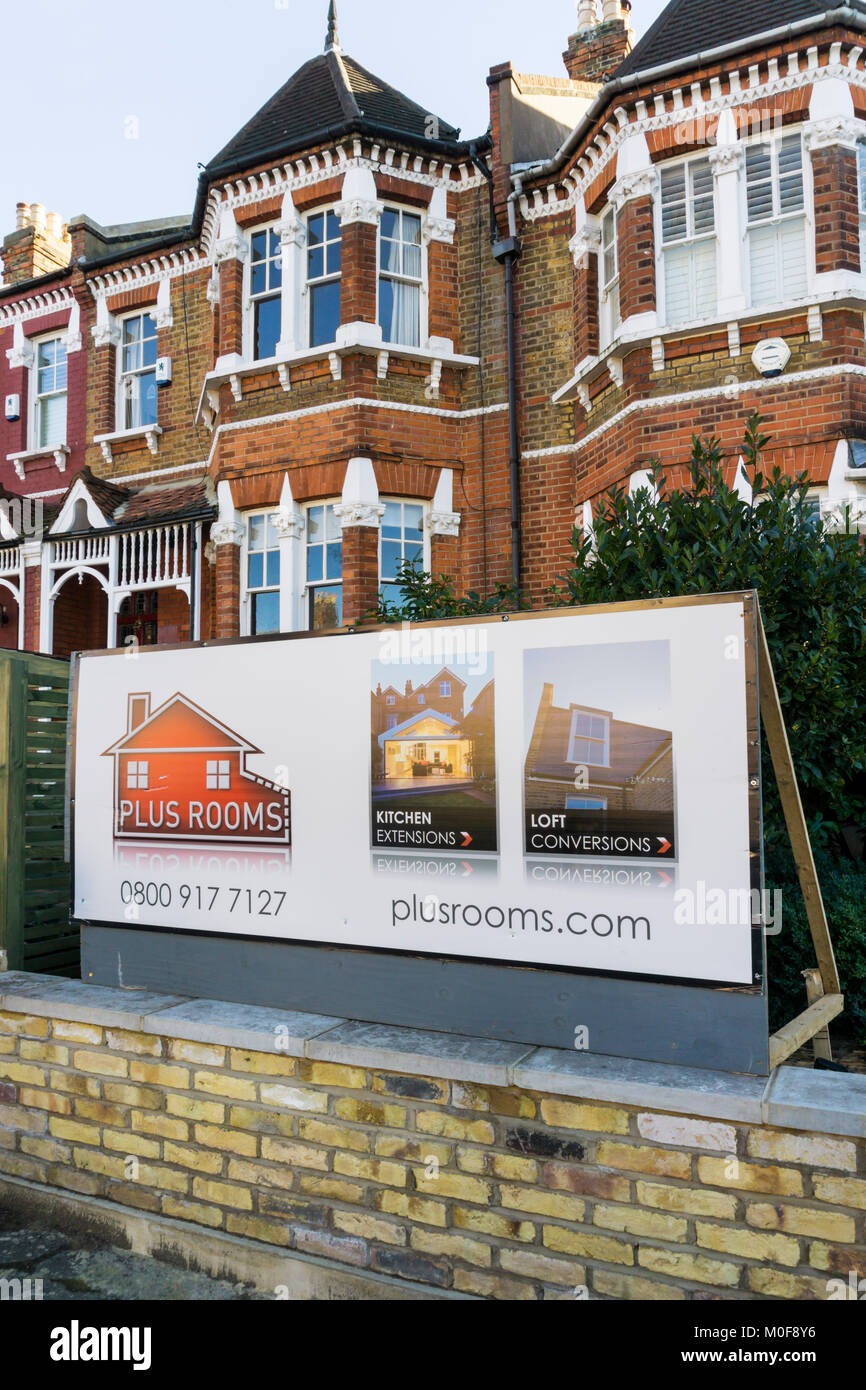 An advert for Plus Rooms loft conversions and extensions in front of a house in South London. Stock Photo