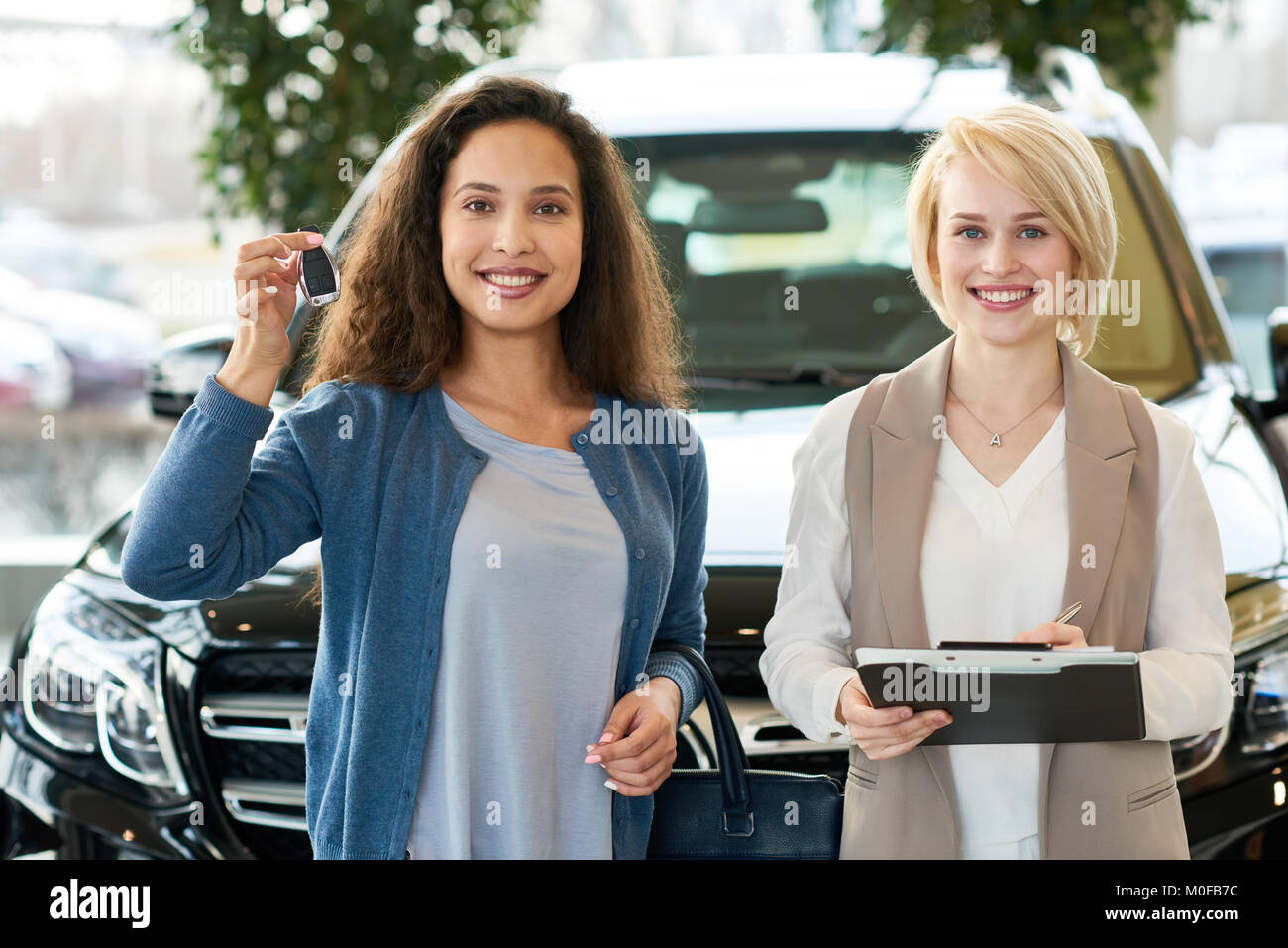 Successful Deal in Car Showroom Stock Photo Alamy