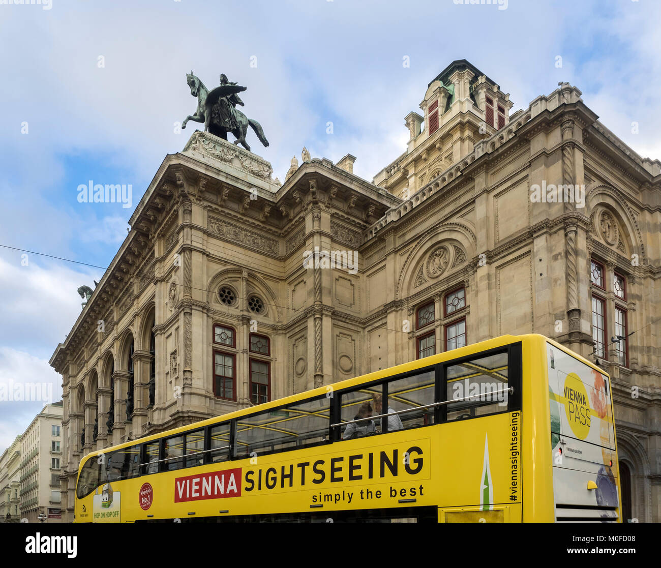 VIENNA, AUSTRIA, DECEMBER 06, 2017:  Sightseeing tour Bus passing Vienna State Opera (Wiener Staatsoper) Stock Photo