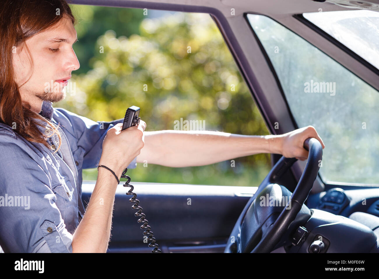Talking while drive, auto walkie talkie, comunication concept. Young