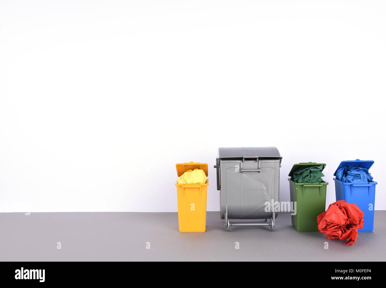 Colorful recycle bins on white background Stock Photo - Alamy