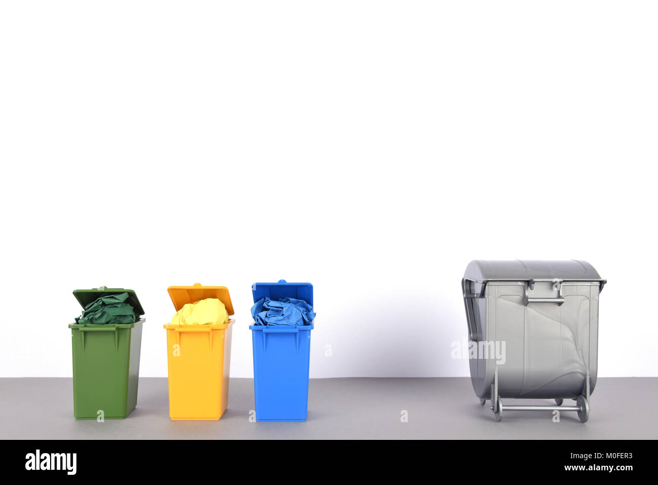 Colorful recycle bins on white background Stock Photo - Alamy