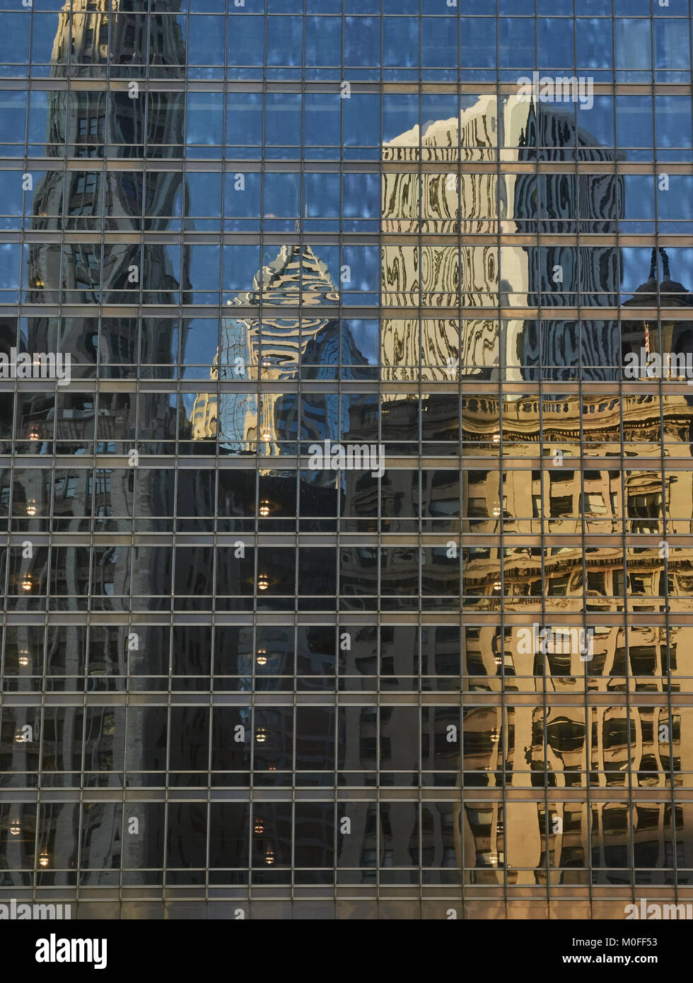 looking up at Chicago buildings reflected in glass Stock Photo