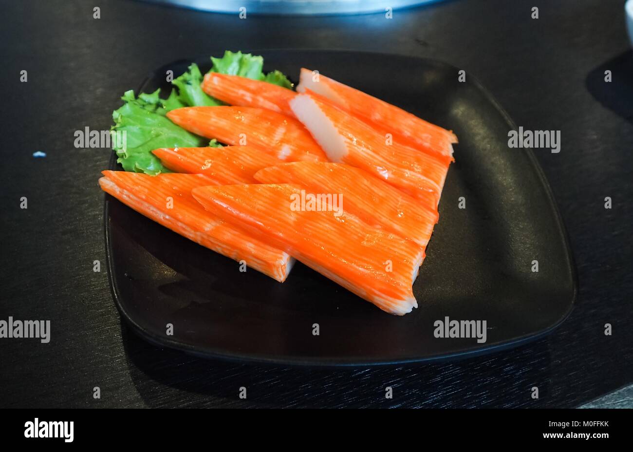 Surimi crab sticks on black plate. Studio Photo Stock Photo Alamy