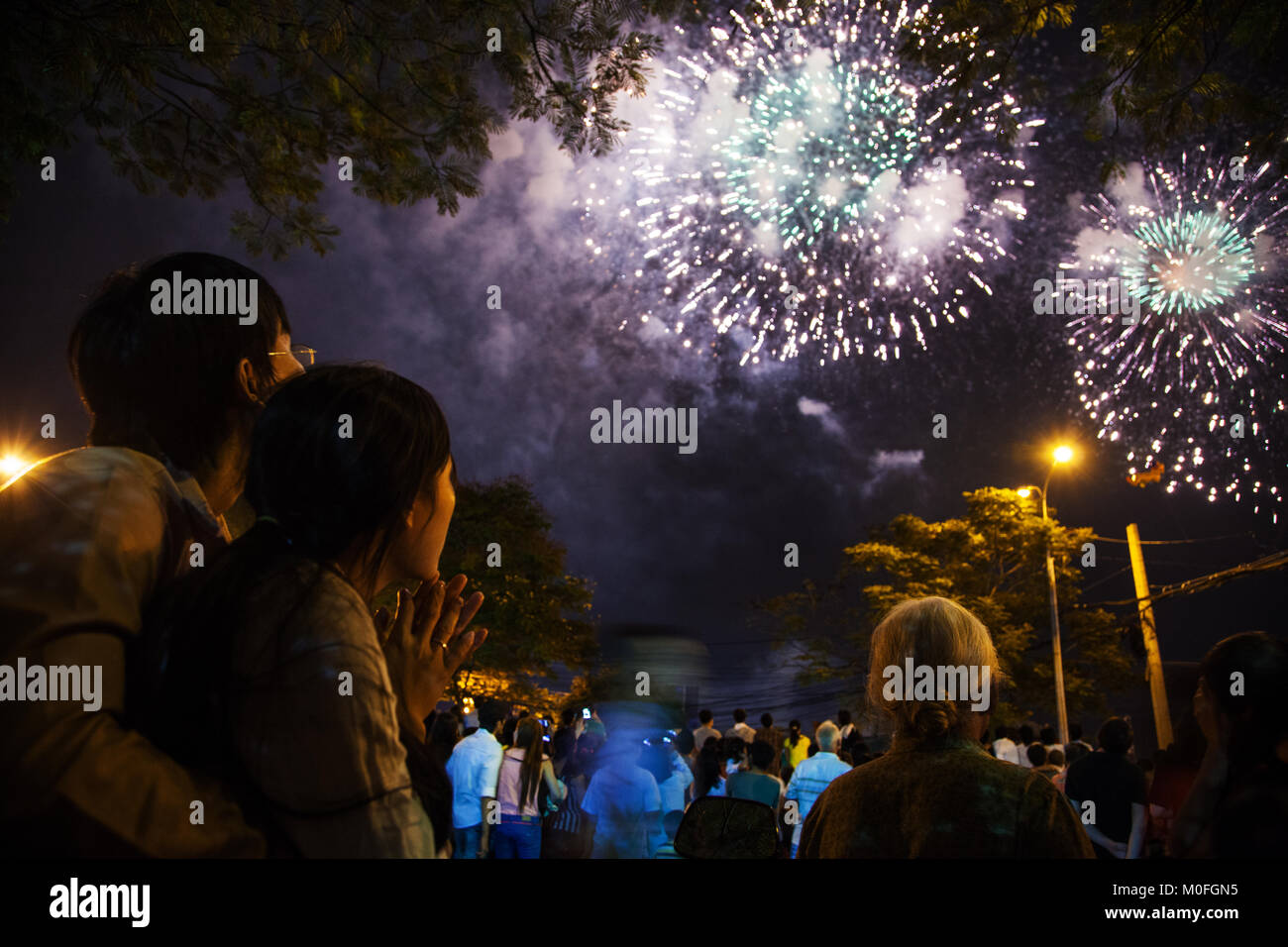 Vietnam - January 22, 2012: Viewers watching fireworks during the celebration of the Vietnamese New Year Stock Photo