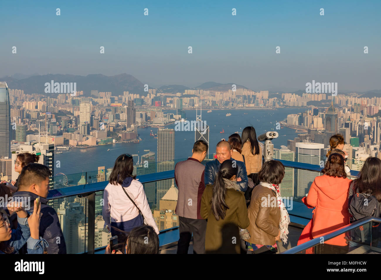 Hong Kong China Asia Jan 13, 2018 Visitors enjoying the evening view of the city and Hong Kong harbour from Victoria Peak Stock Photo