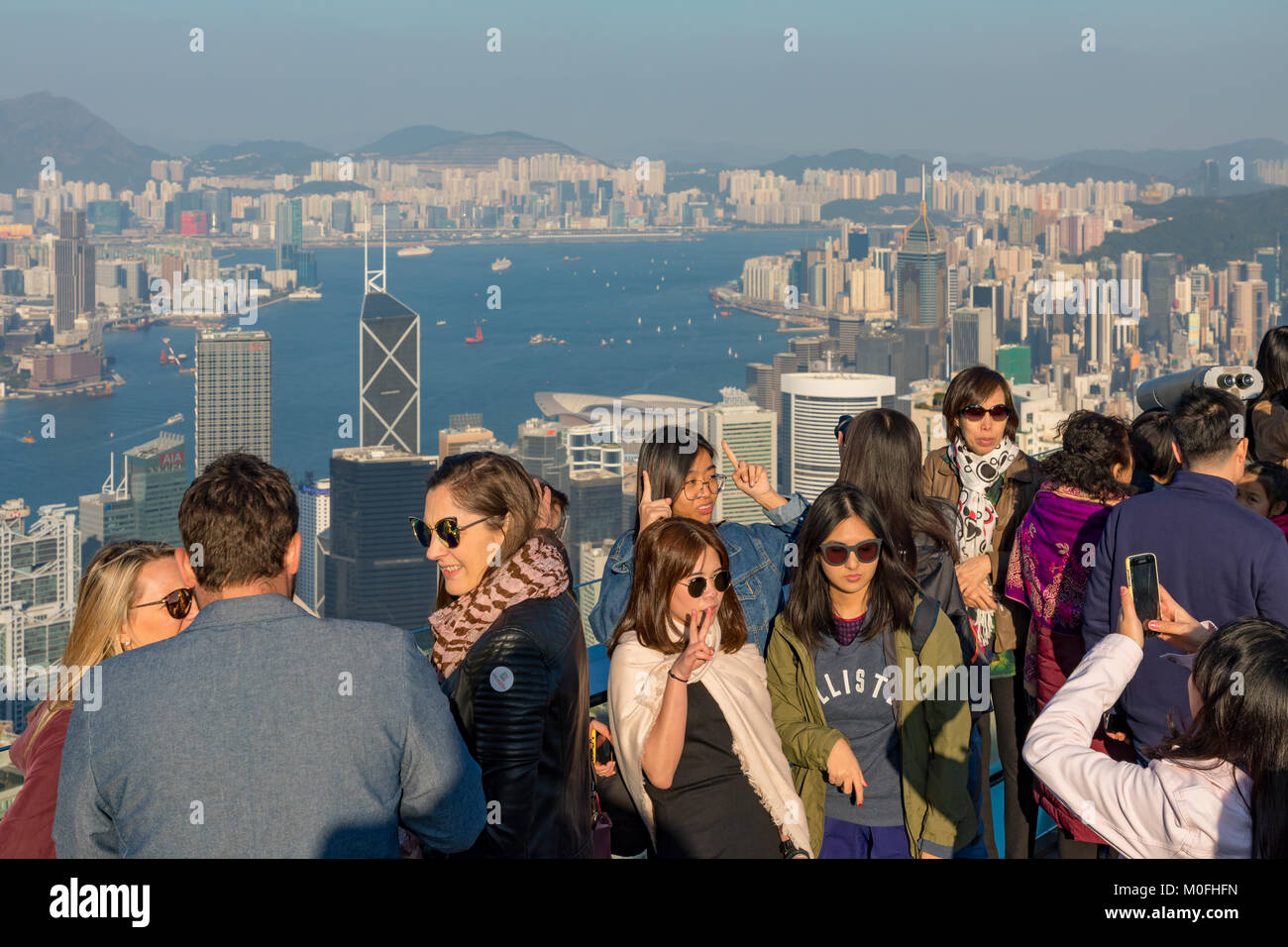 Hong Kong China Asia Jan 13, 2018 Visitors enjoying the evening view of the city and Hong Kong harbour from Victoria Peak Stock Photo