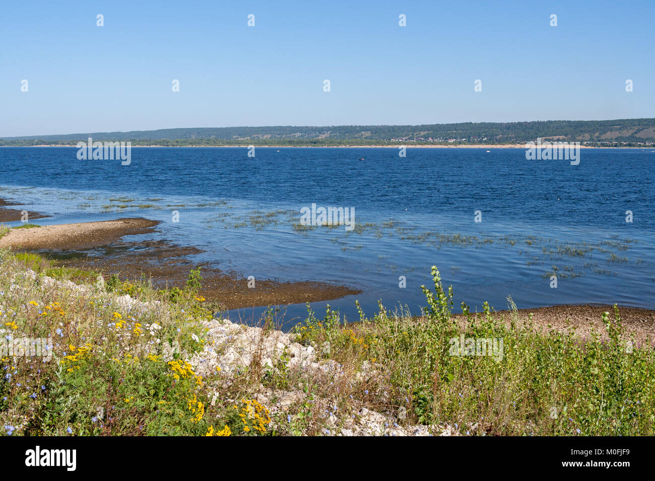 Shallow shore of Volga river on summer morning. Stock Photo