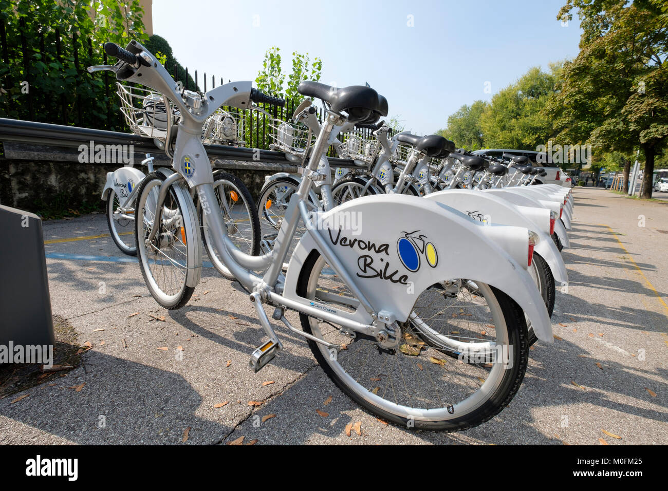 Bicycles ready for hire at a Verona bike sharing/rental station, Verona, Veneto, Italy Stock Photo