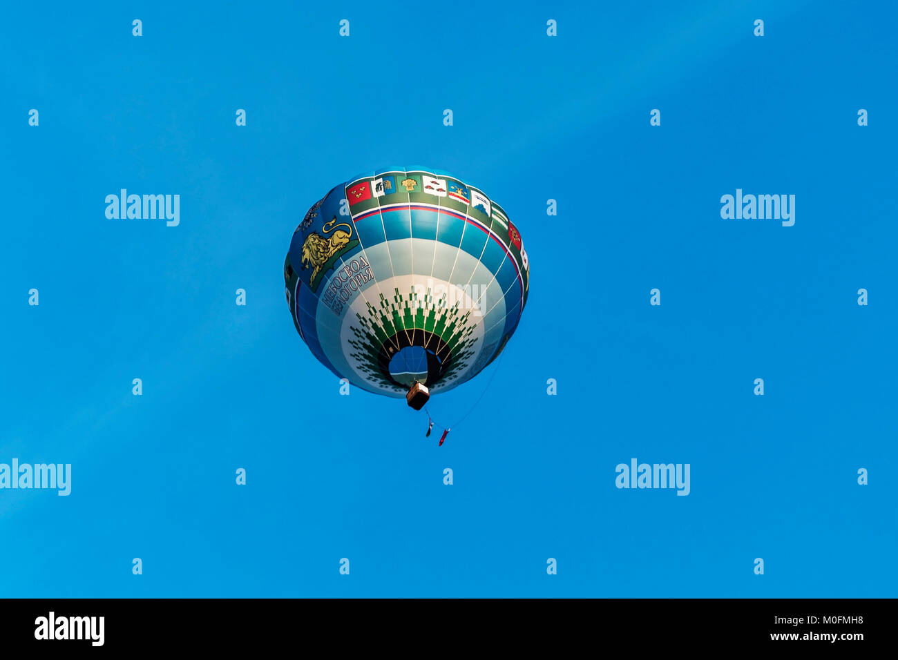 Belarus, Minsk - 2017.09.17: balloon says 'Sky mountains' in the background of blue sky at the festival of Aeronautics (bottom view) Stock Photo