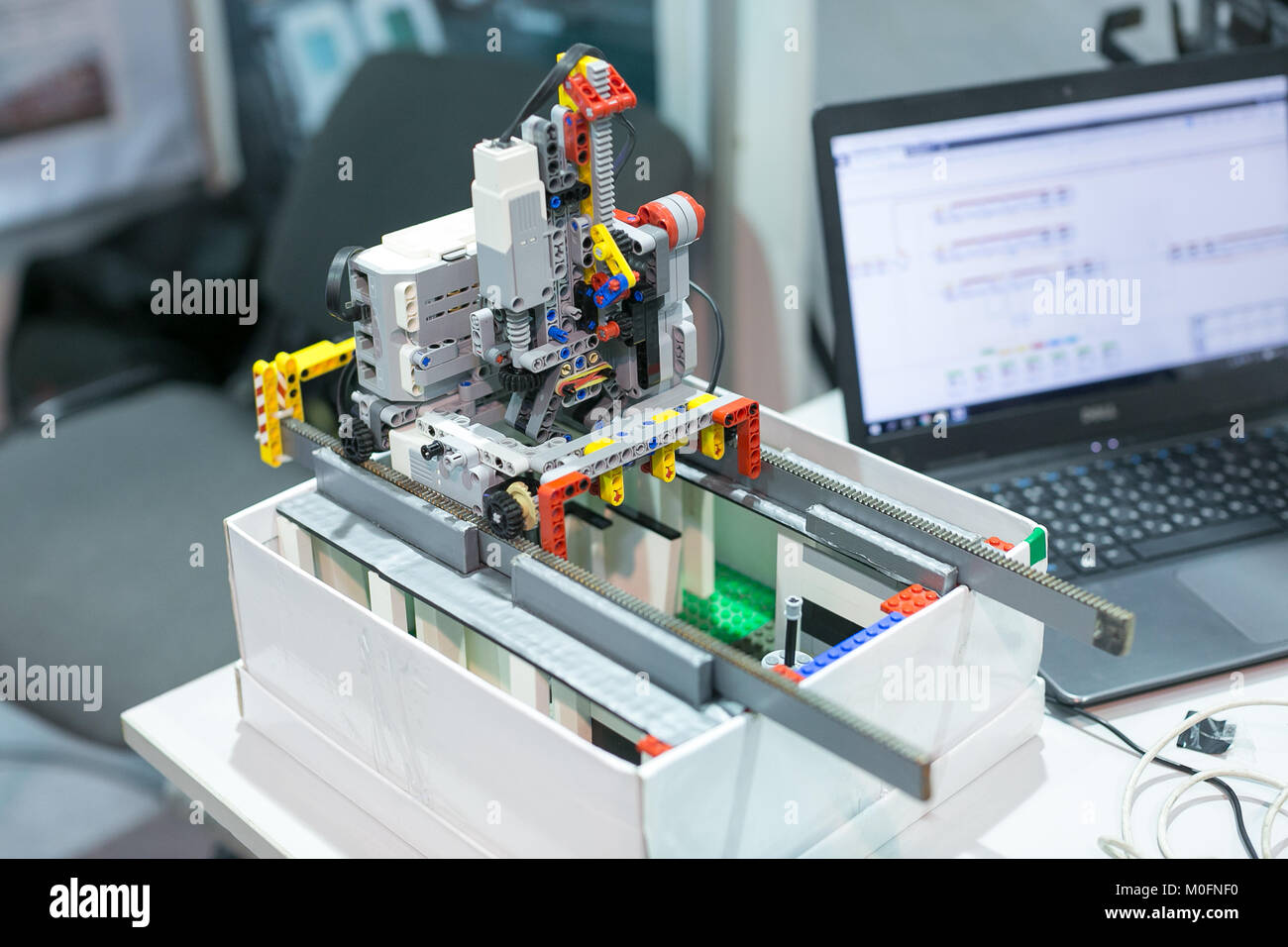 science, engineering, technological revolution concept. there is unusual electronic device created of small details of lego construction kit and conne Stock Photo