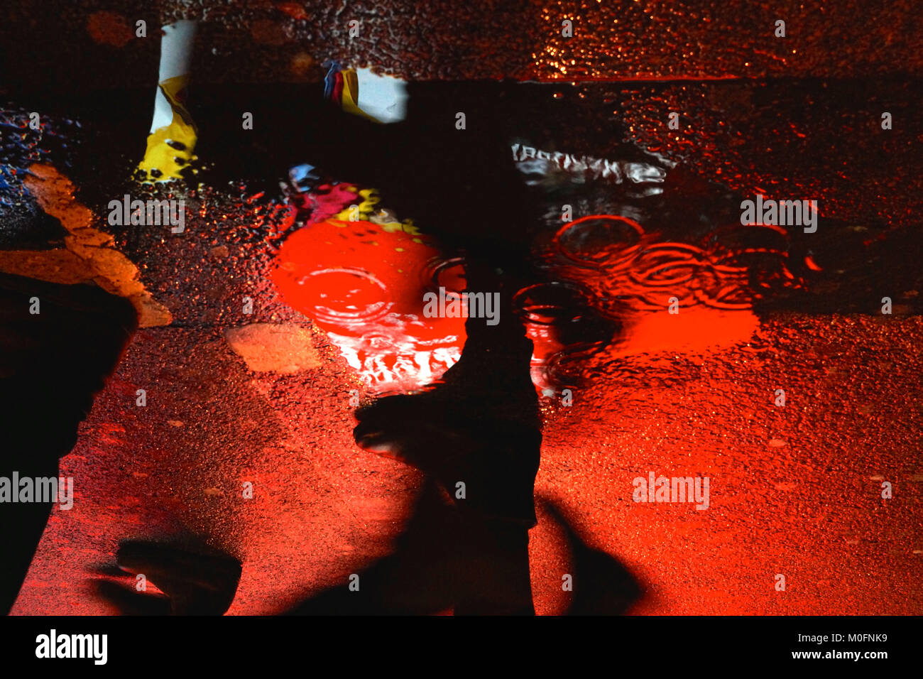 Coca cola advertisement reflected in a puddle at Piccadilly Circus, London Stock Photo