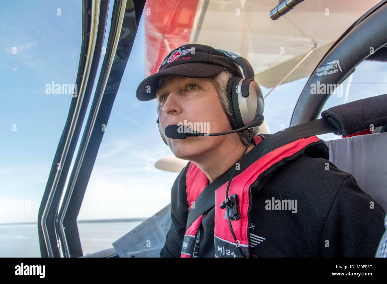 Female copilot gazes out from cockpit of Searey seaplane Stock Photo