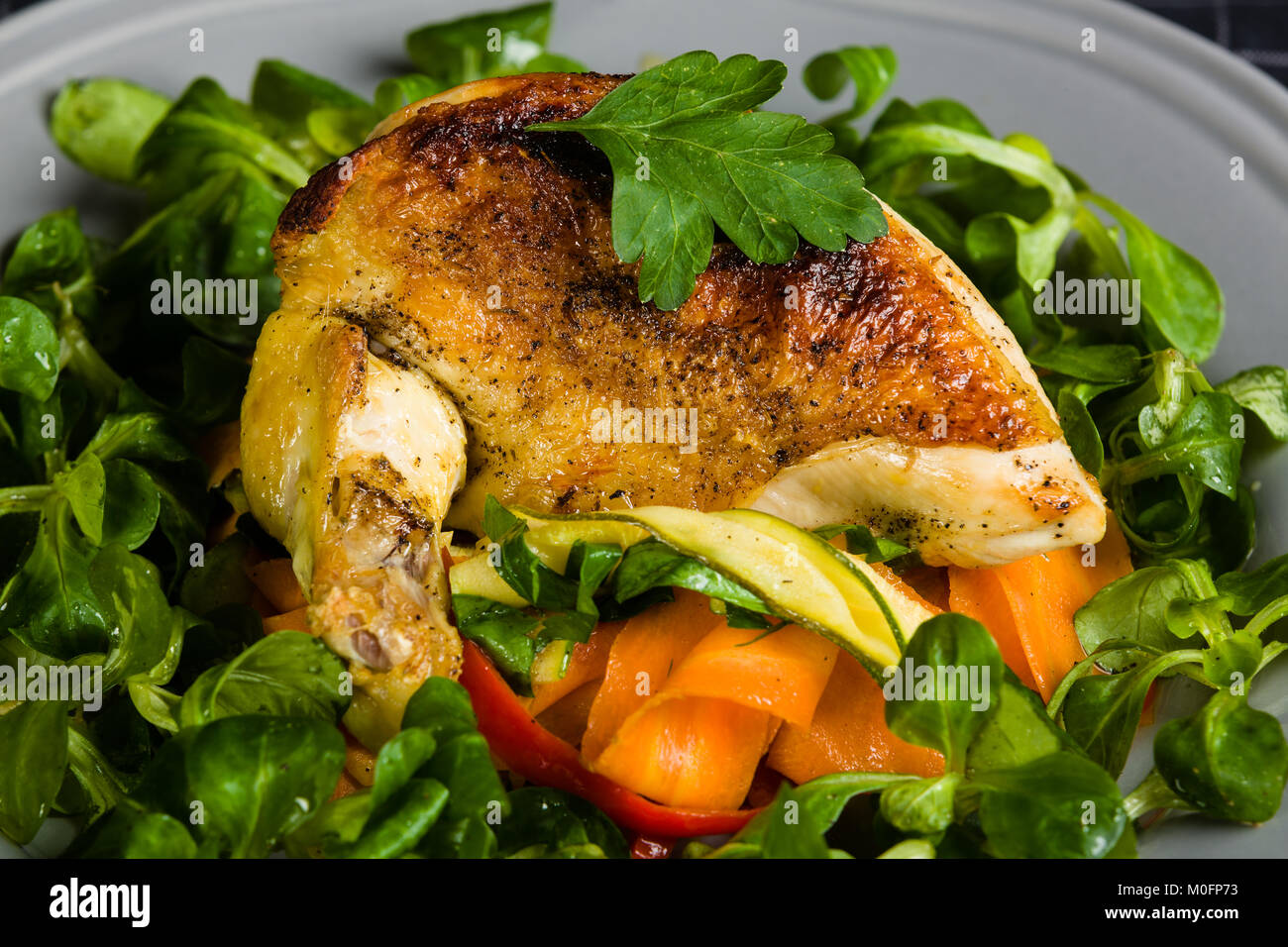 Chicken Supreme on vegetable pappardelle with corn salad Stock Photo