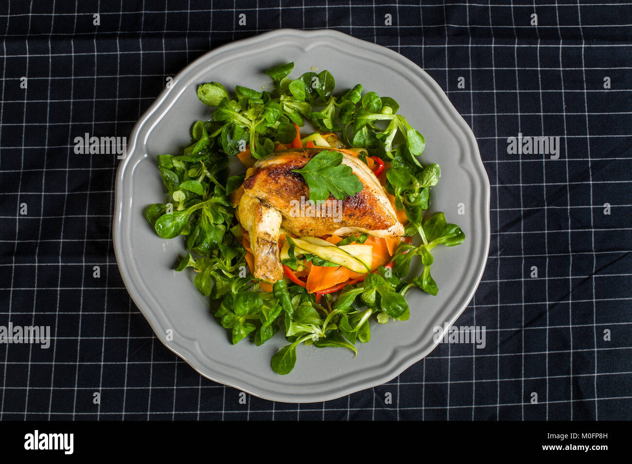 Chicken Supreme on vegetable pappardelle with corn salad Stock Photo
