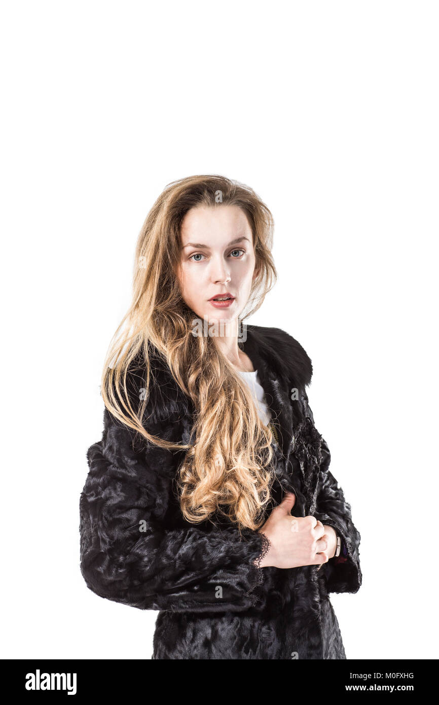 portrait of young business woman in a black coat on a white background ...