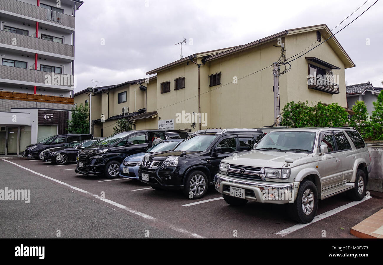 Kyoto, Japan Nov 28, 2016. Car parking lot with apartments at