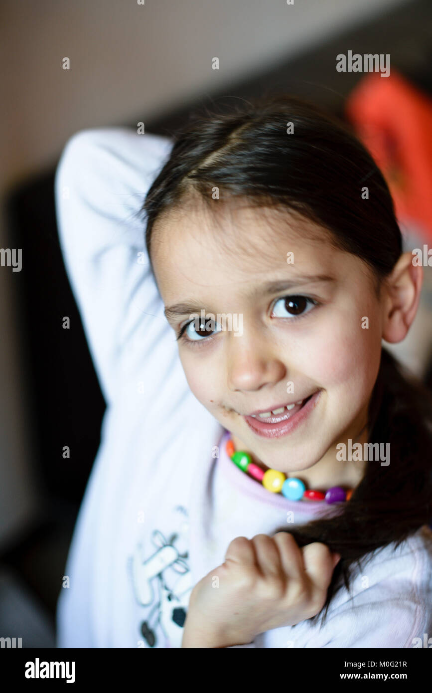 Portrait Of A 5 Year Old Girl Wearing Pajamas In Her Home In The Hall portrait-of-a-5-year-old-girl-wearing-pajamas-in-her-home-in-the-hall