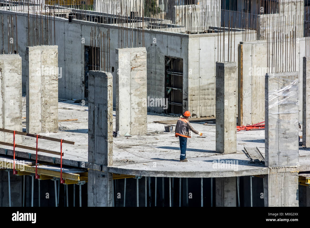 Close up of construction site of new concrete building and people