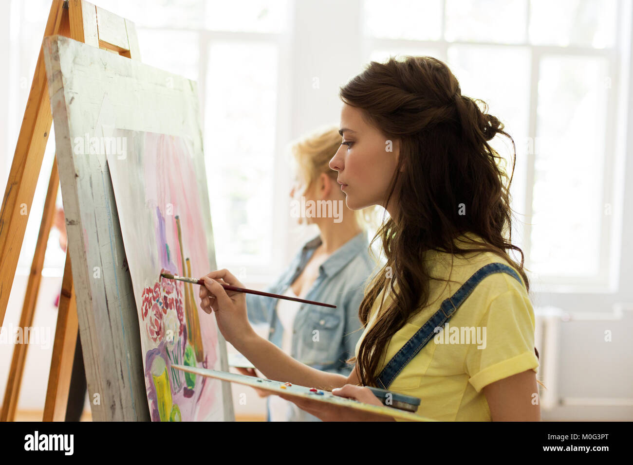 woman with easel painting at art school studio Stock Photo - Alamy