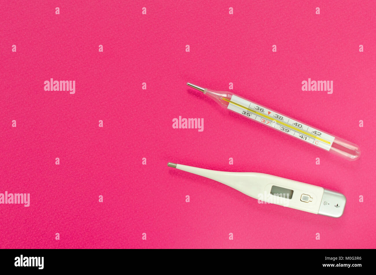 mercury and digital thermometers on pink background Stock Photo Alamy