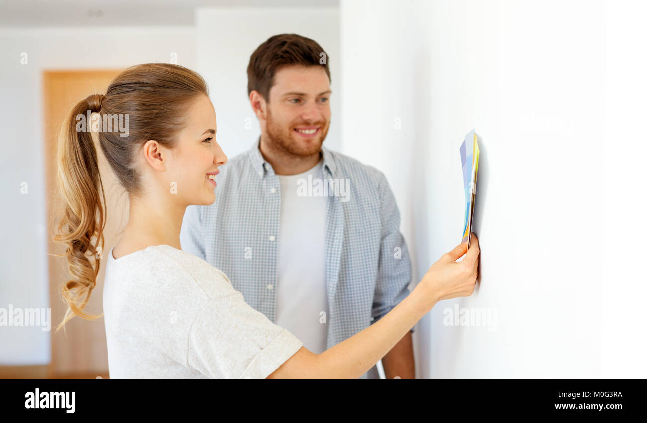 happy couple with color samples at new home Stock Photo