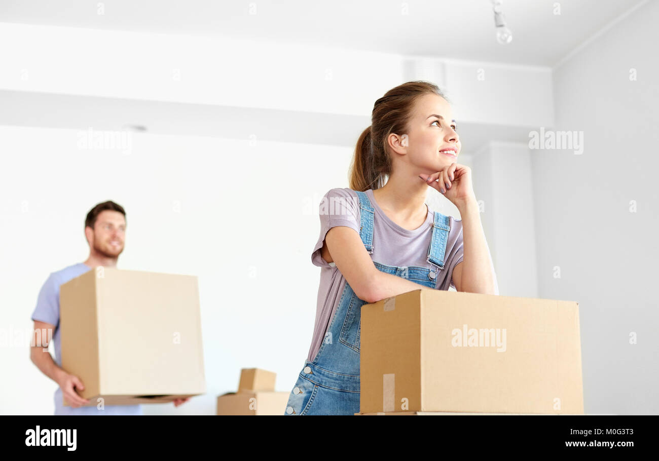 happy couple with boxes moving to new home Stock Photo - Alamy