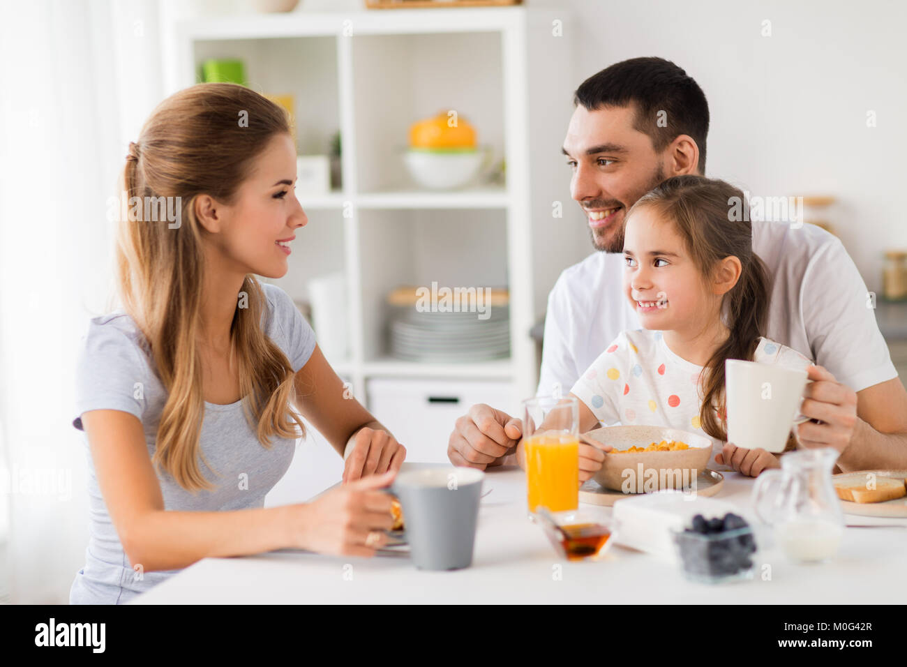 happy family having breakfast at home Stock Photo - Alamy