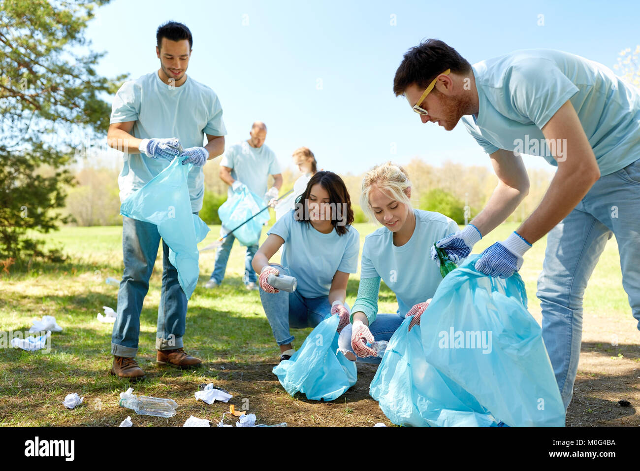 Young smiling volunteers cleaning hi-res stock photography and images ...