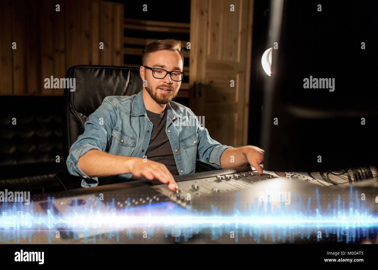 sound engineer at recording studio mixing console Stock Photo