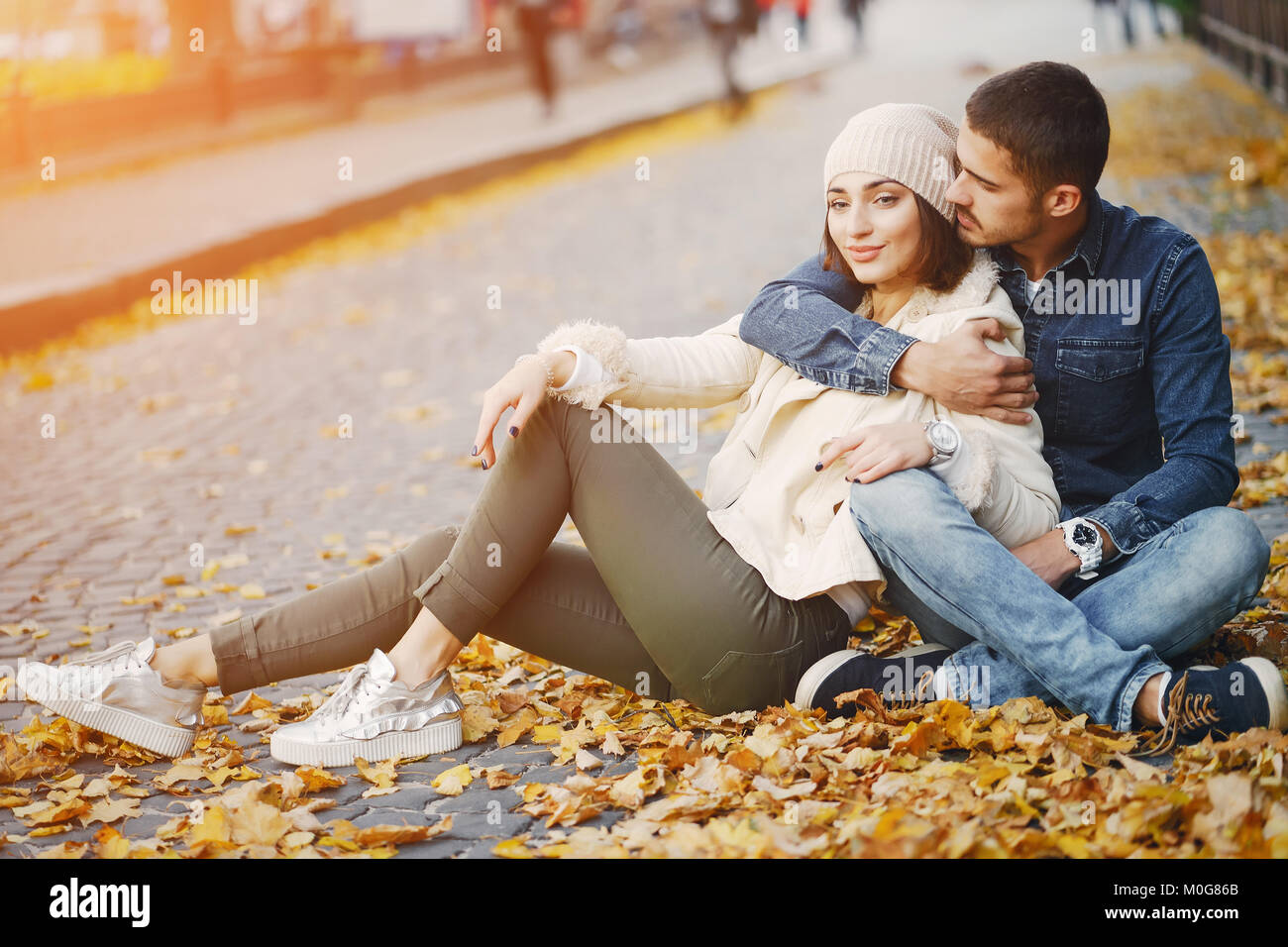 Couple Sitting and Hugging on Stone · Free Stock Photo