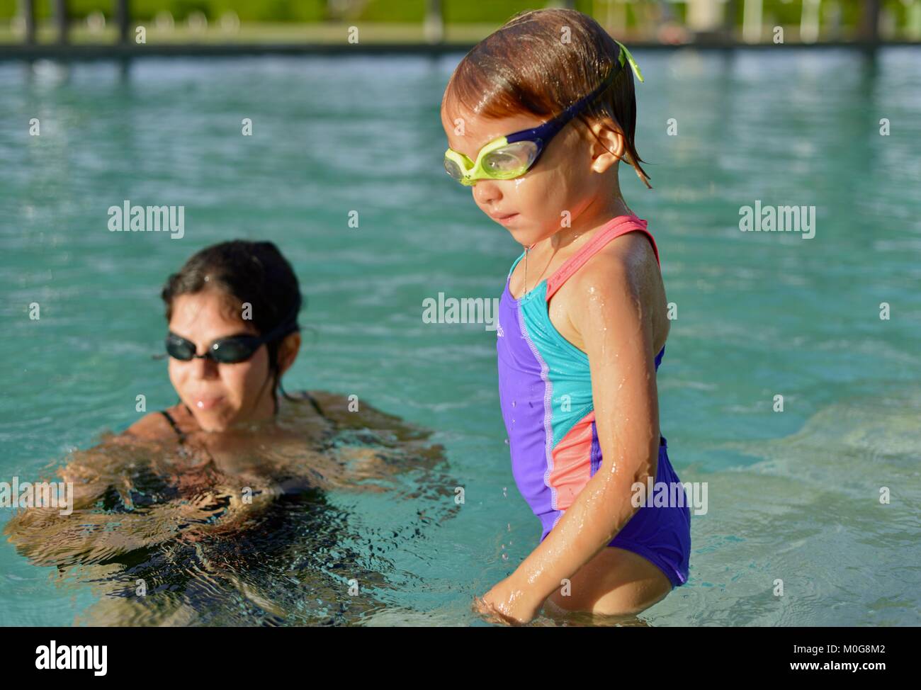 Mother teaches daughter to swim, Riverway pool, Townsville, Queensland