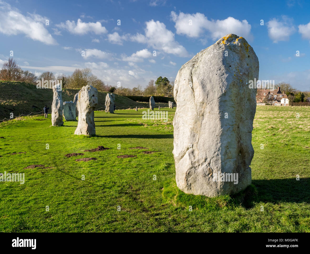 Avebury is a Neolithic henge monument containing three stone circles, and various barrows near the village of Avebury in Wiltshire, England. Stock Photo