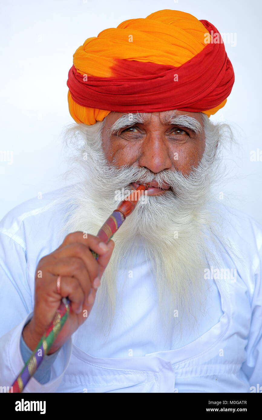 JODHPUR, RAJASTHAN, INDIA - DECEMBER 17, 2017: Portrait of a man with long white mustache and beard and an orange turban in  Mehrangarh fort Stock Photo