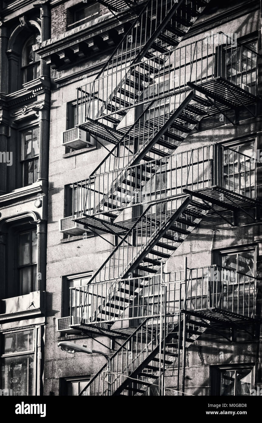 Outside metal fire escape stairs, New York City, black and white Stock Photo