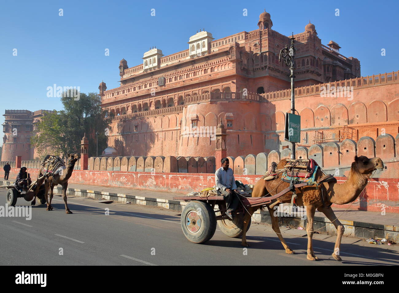 BIKANER, RAJASTHAN, INDIA - DECEMBER 23, 2017: 2 carriages with camels in front of Junagarh Fort Stock Photo