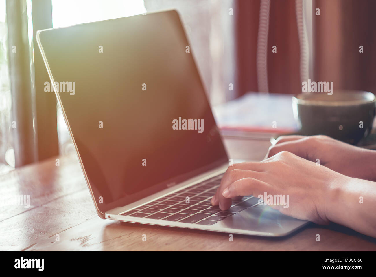 Woman hands typing on laptop on table in coffee shop ,concept for freelance can working any time anywhere Stock Photo