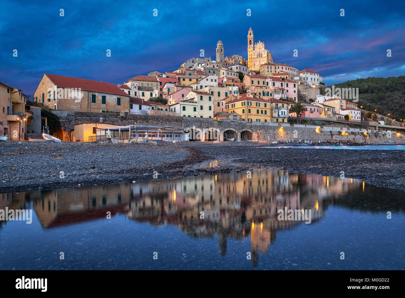 Old ligurian town Cervo reflecting in water at dusk, Province of Imperia, Liguria, Italy Stock Photo