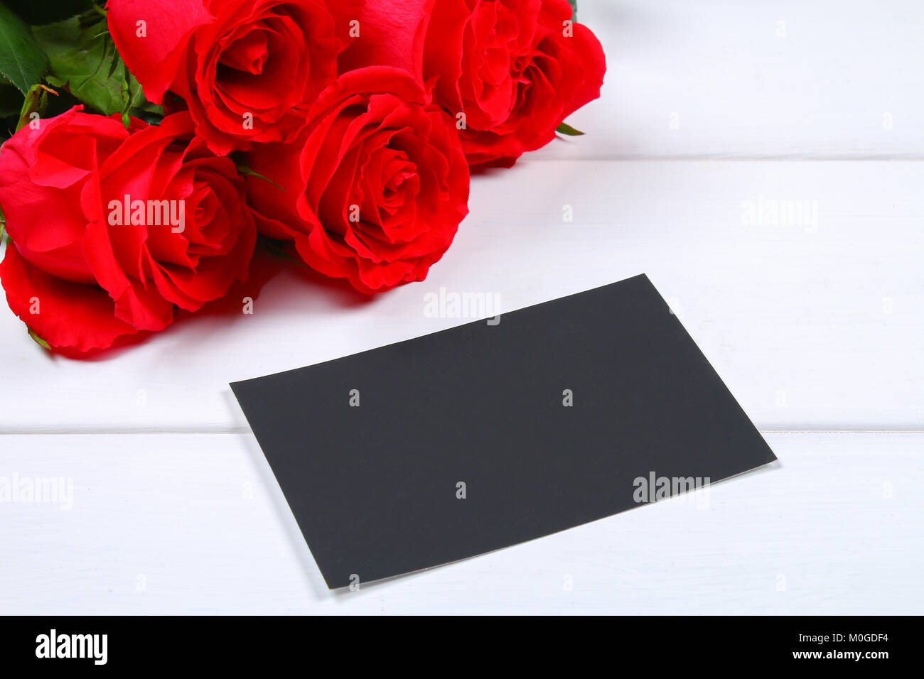 Pink roses with a blank chalkboard for text. Copy space for text ...