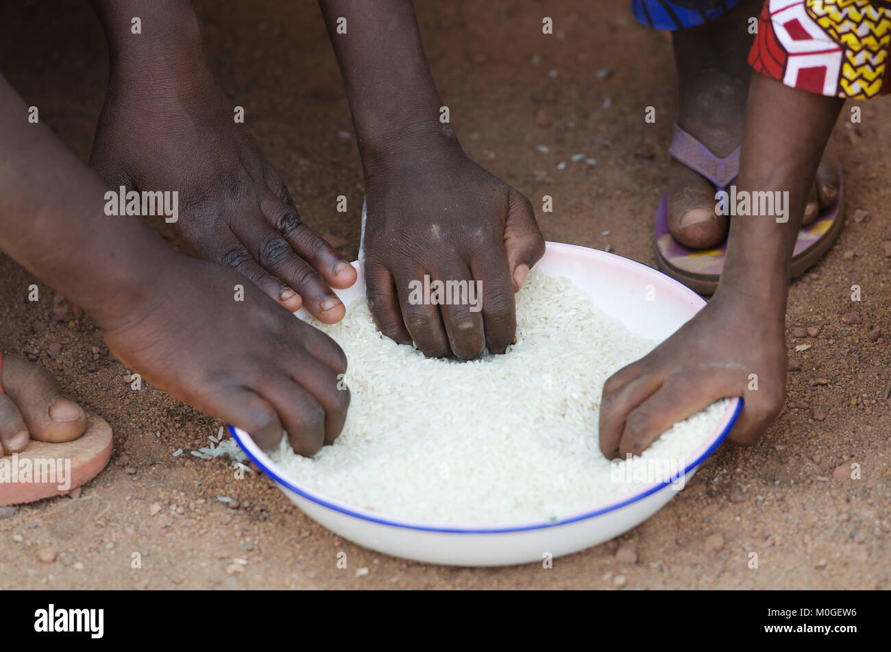 Closeup of African children eating a meal outdoors Stock Photo