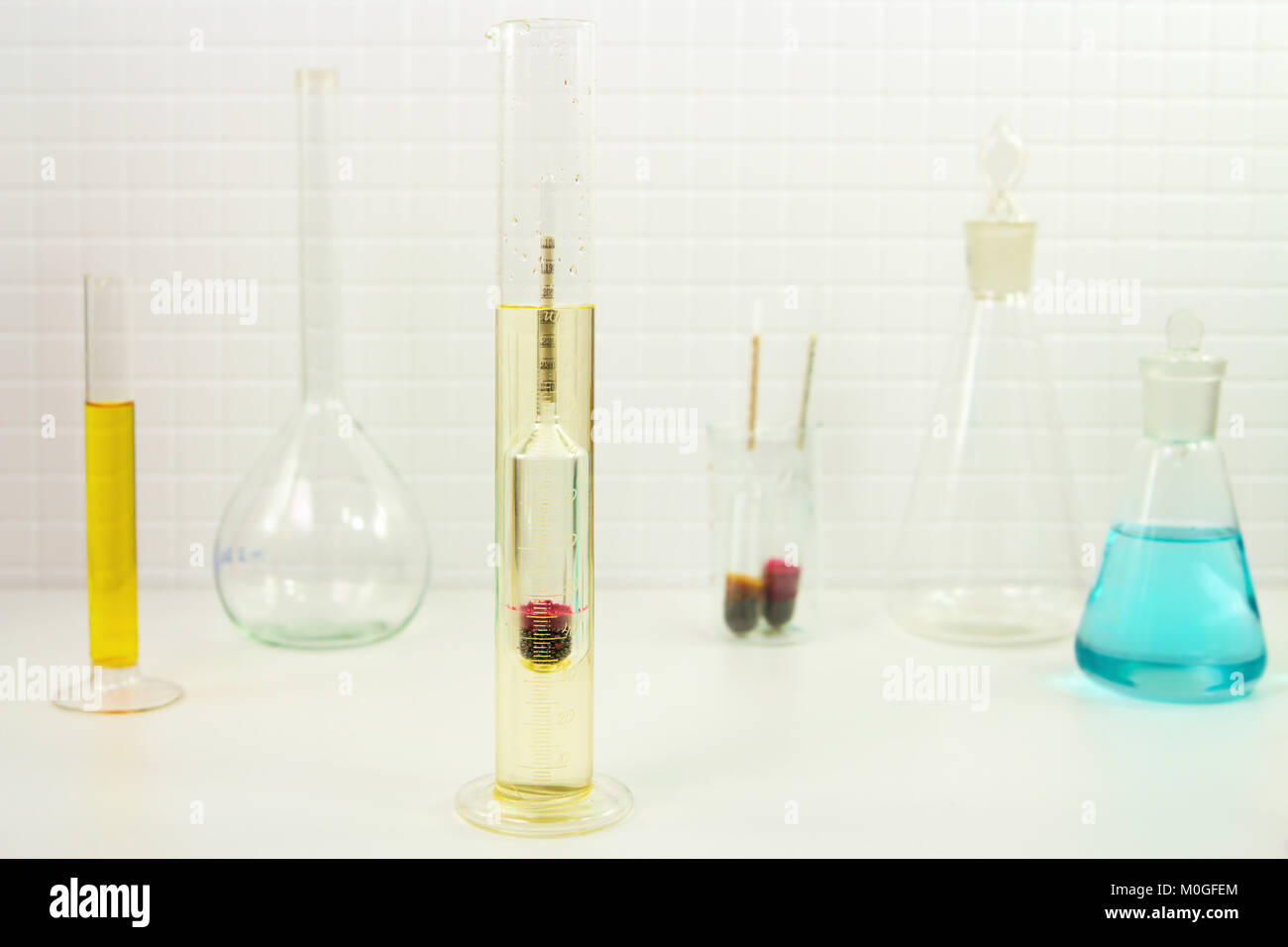 Measurement of solution density with a glass hydrometer in a lab Stock Photo