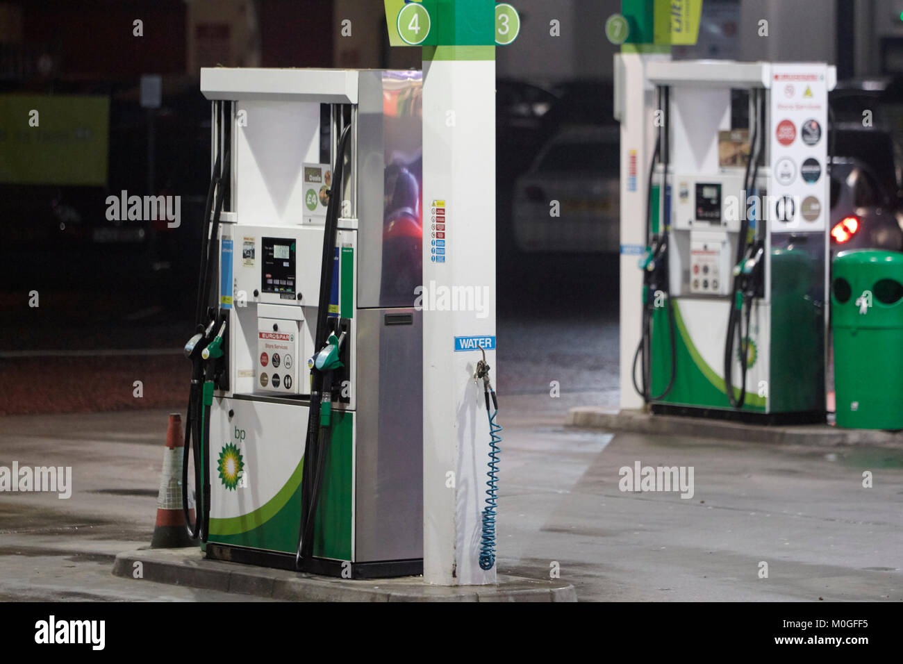 bp garage forecourt with automatic petrol pumps at night in the uk Stock Photo