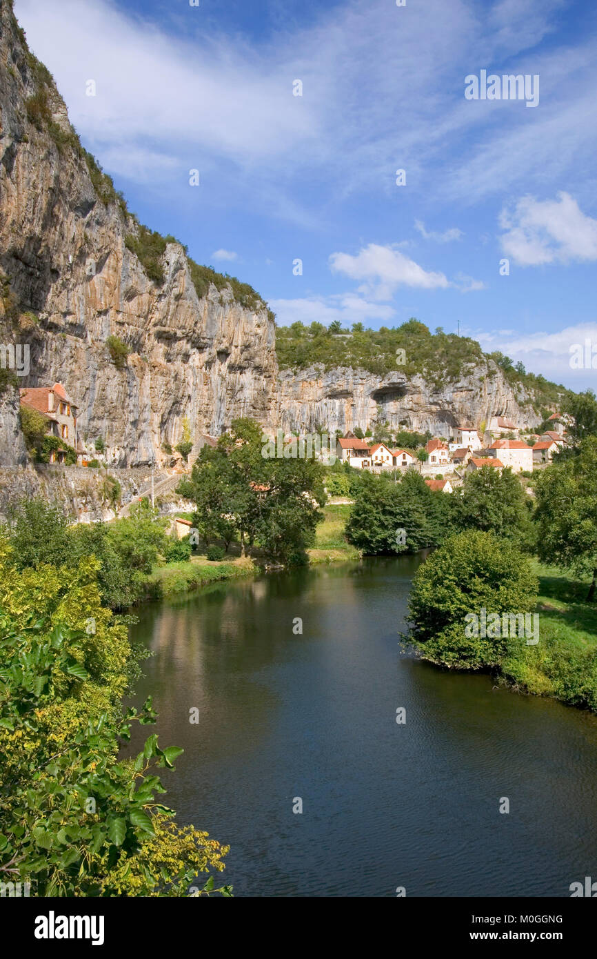 Quaint village houses sit between the cliffs and the River Cele in