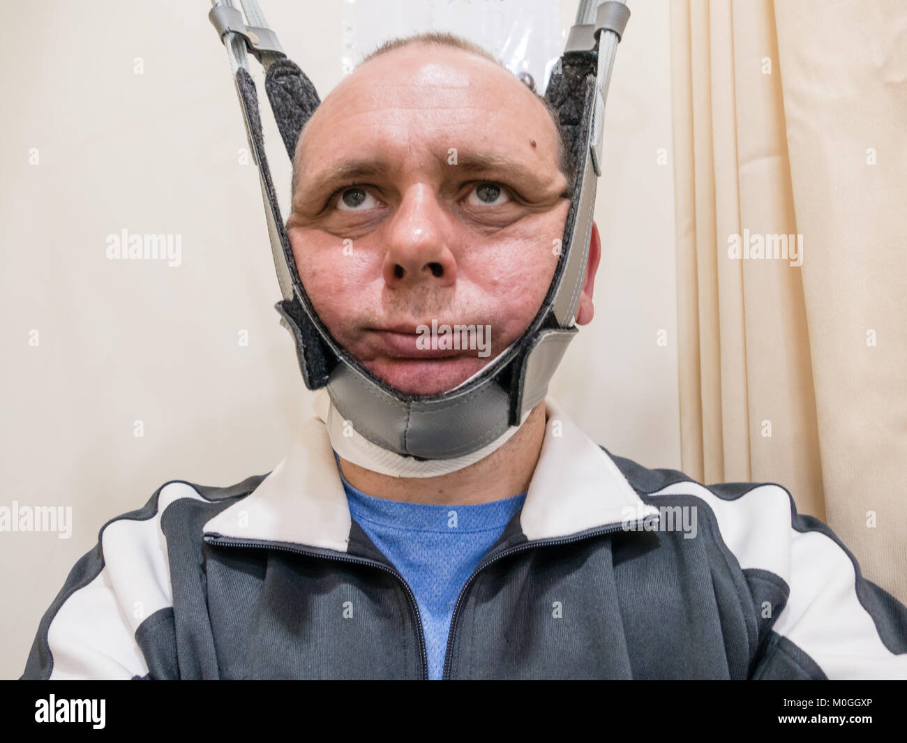 Man in neck traction machine for physiotherapy Stock Photo Alamy