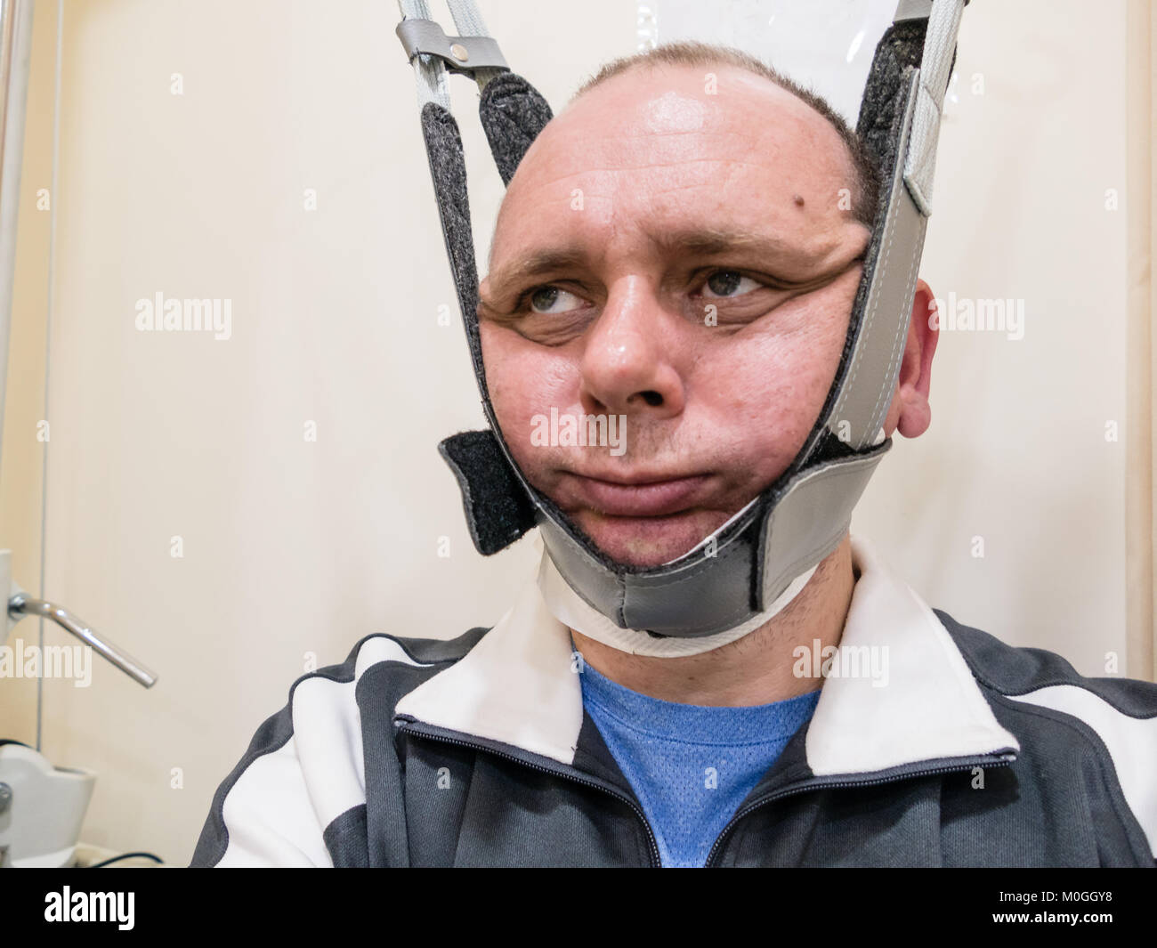Man in neck traction machine for physiotherapy Stock Photo Alamy