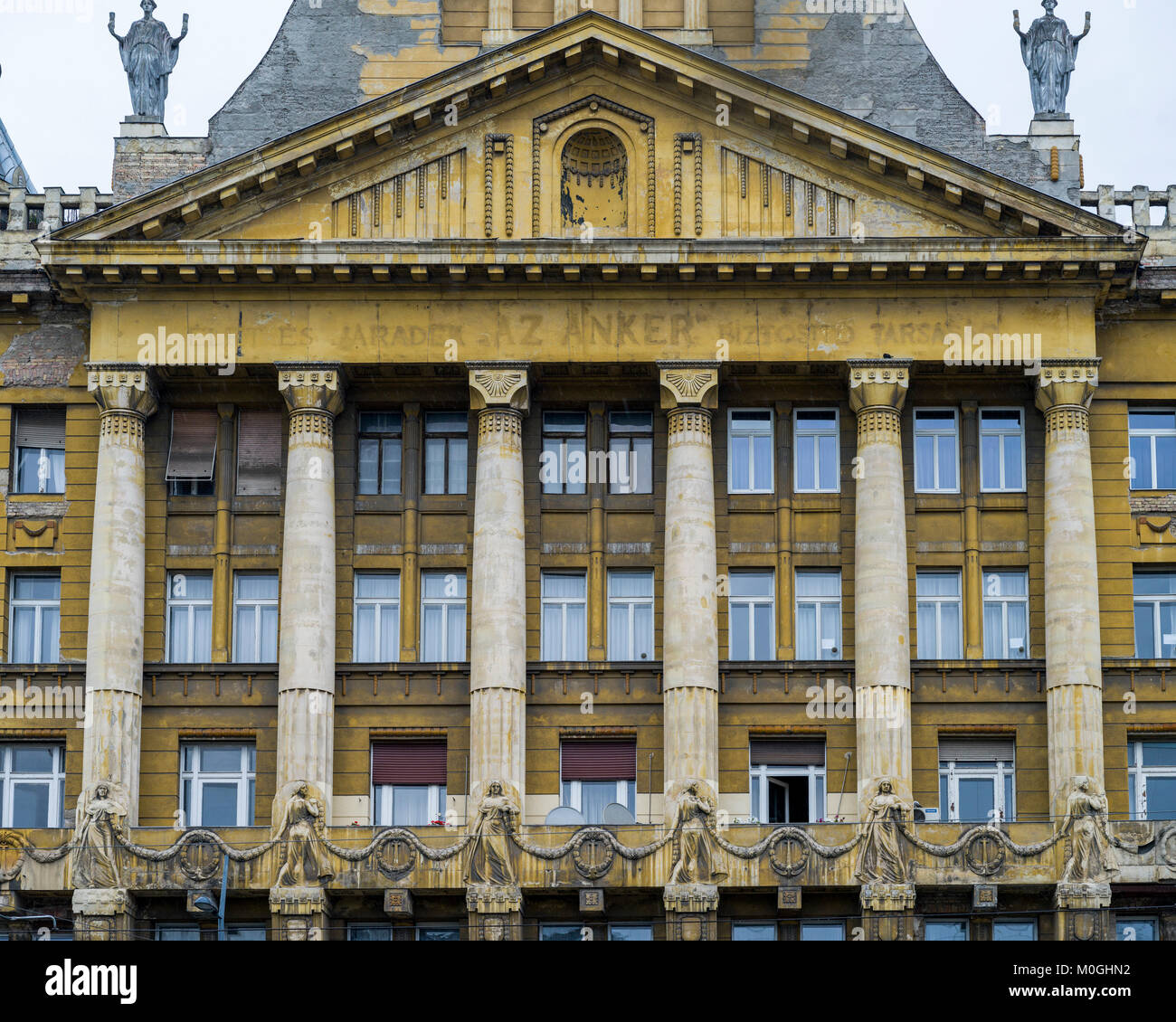 Building with weathered facade of columns and windows and decorative ...