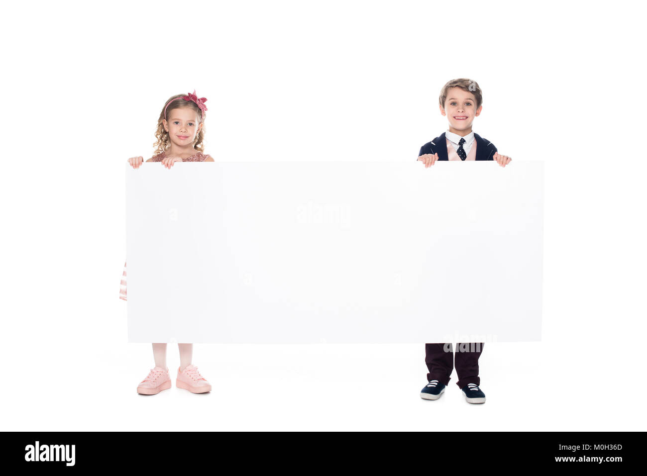 cute little kids holding blank banner and smiling at camera isolated on ...