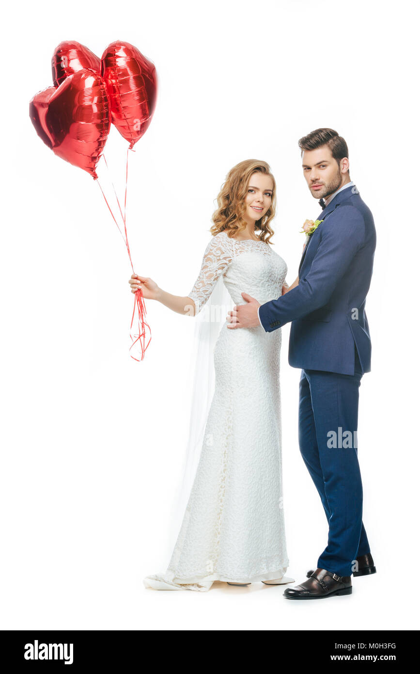 wedding couple with red heart shaped balloons isolated on white Stock ...