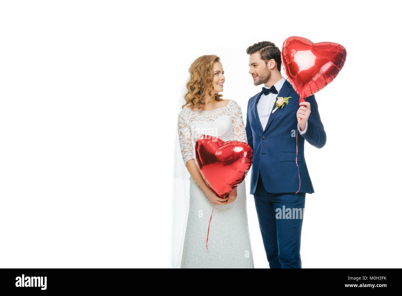 wedding couple with red heart shaped balloons isolated on white Stock ...